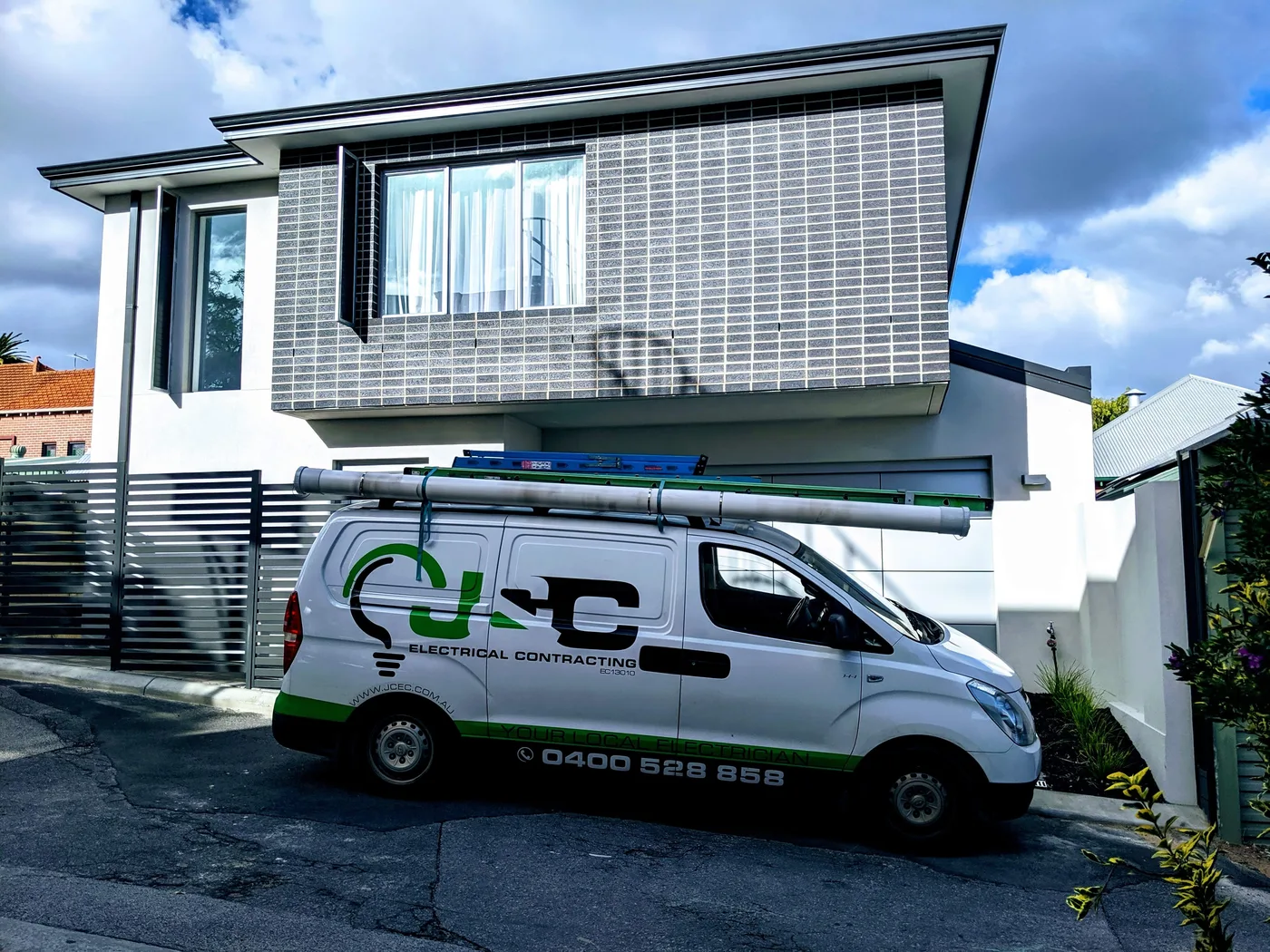 J & C van outside a completed Perth home